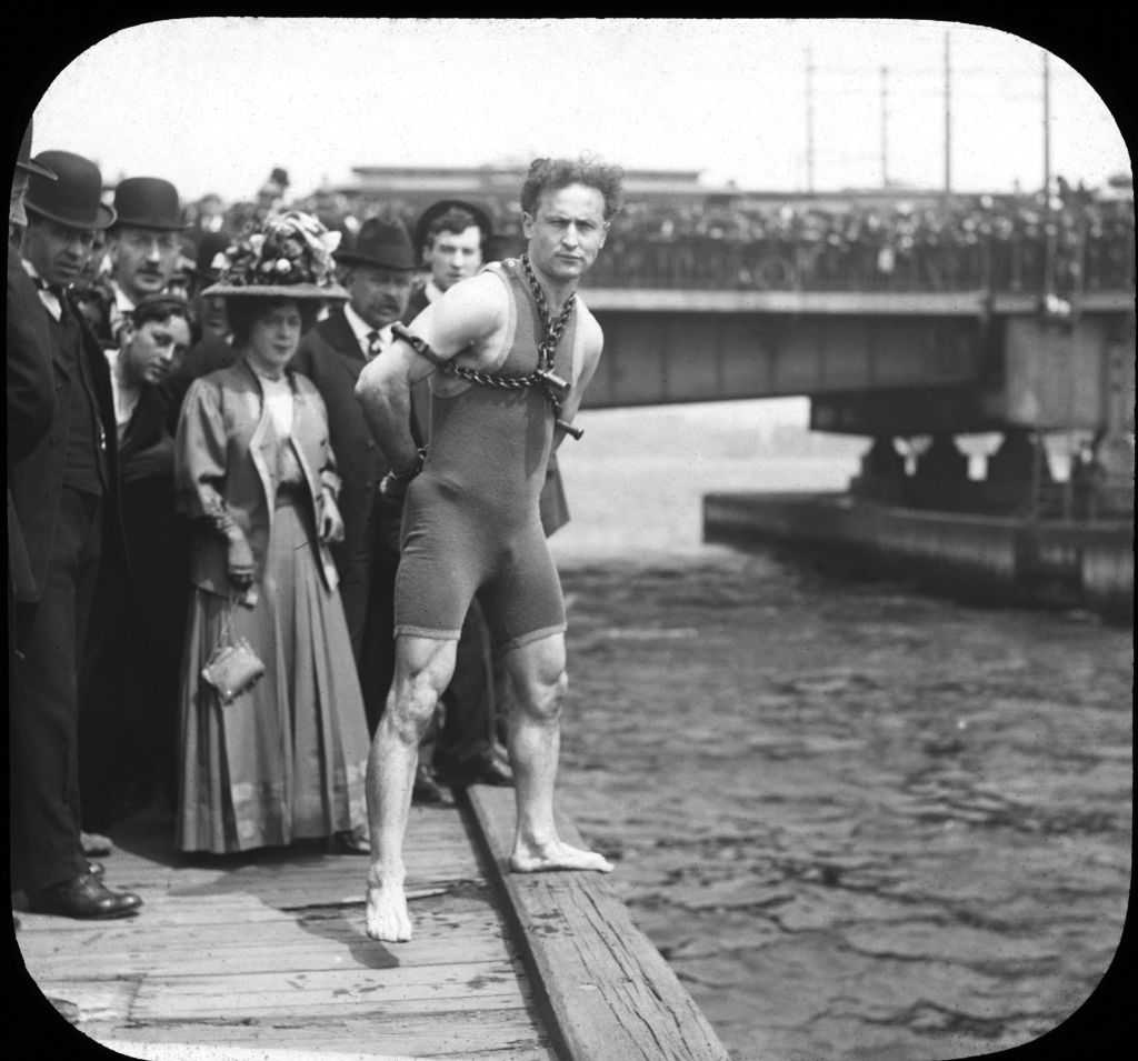 Harry Houdini performing a magic trick on stage